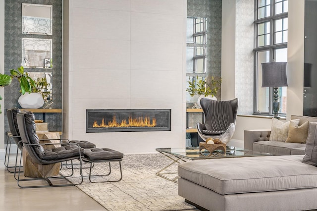 sitting room with concrete flooring and a tile fireplace