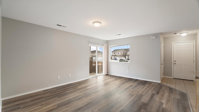 empty room with hardwood / wood-style floors