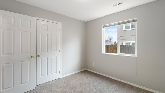 unfurnished bedroom featuring light colored carpet