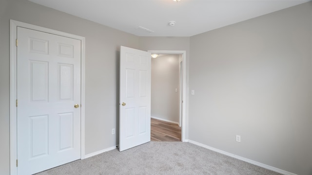 unfurnished bedroom featuring light carpet