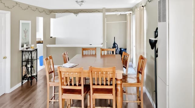 dining room with wood-type flooring