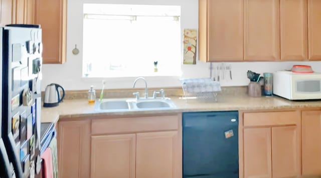 kitchen featuring light brown cabinets, black dishwasher, sink, and refrigerator