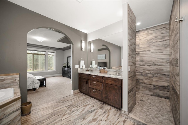 bathroom with vanity and a tile shower