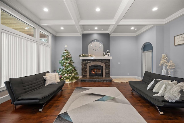 living room featuring coffered ceiling, ornamental molding, dark hardwood / wood-style flooring, beamed ceiling, and a fireplace