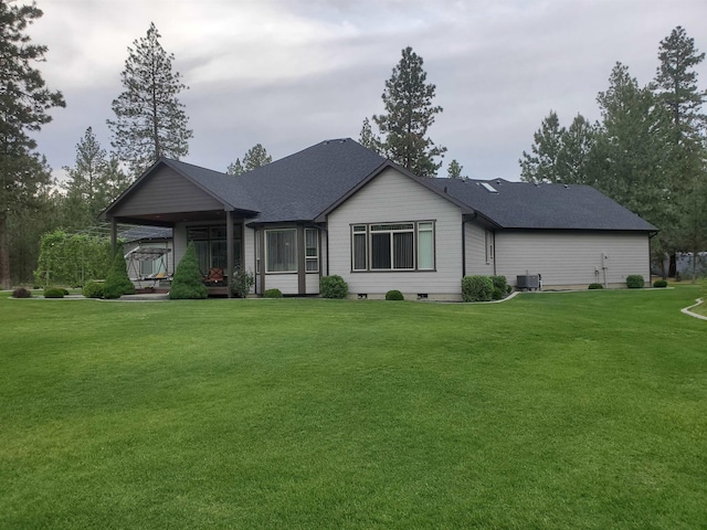 view of front of house featuring central AC, a front yard, and a porch