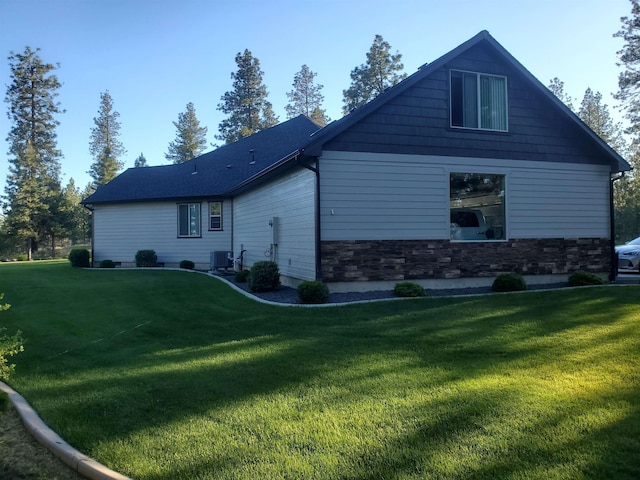 back of property featuring a yard and central AC unit