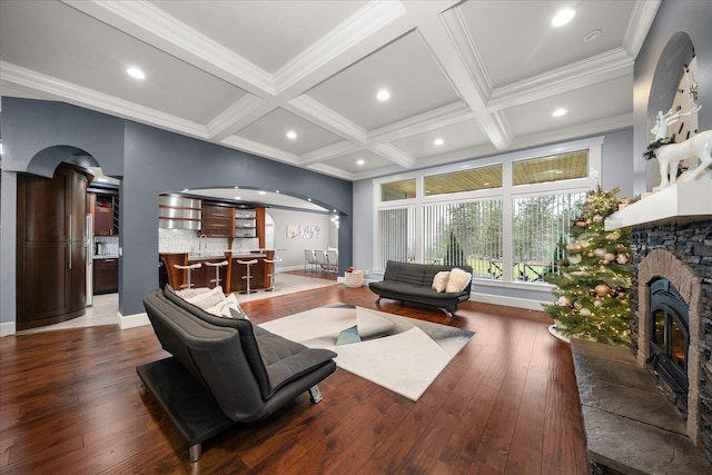 living room featuring beamed ceiling, coffered ceiling, and hardwood / wood-style floors