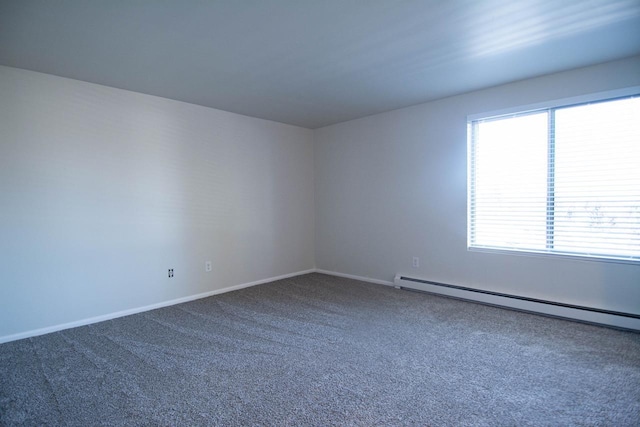 carpeted spare room featuring a baseboard radiator