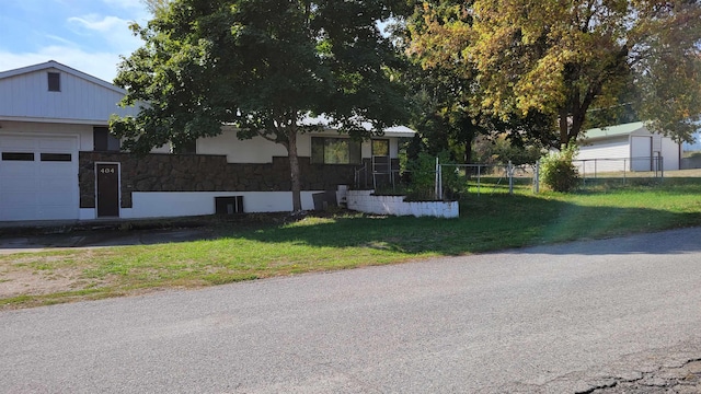 view of front of property with a front yard and a garage