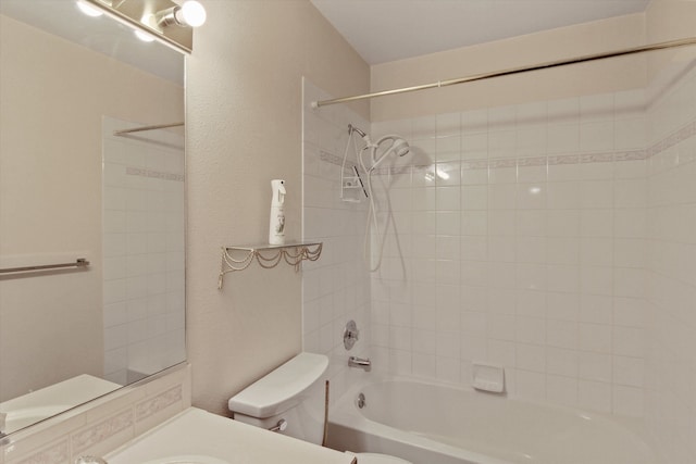 full bathroom with vanity, toilet, and tiled shower / bath combo