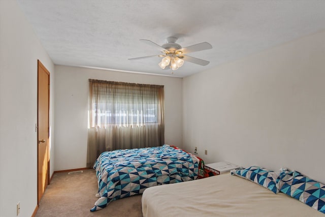 bedroom with ceiling fan and light colored carpet