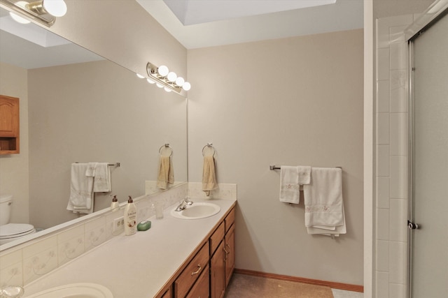 bathroom with toilet, vanity, and a shower with shower door