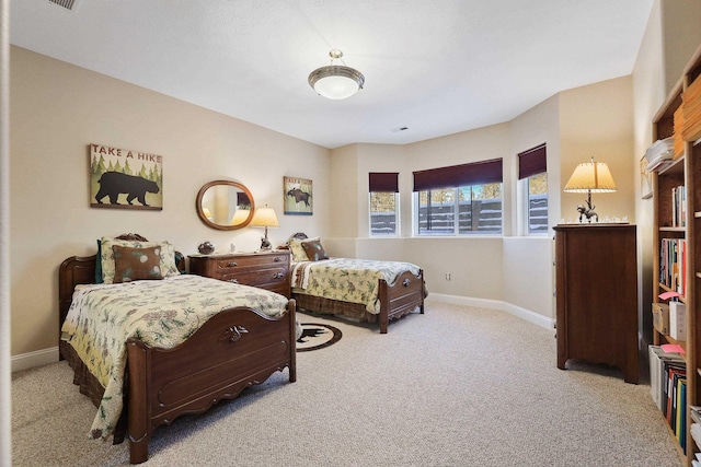 bedroom featuring light carpet