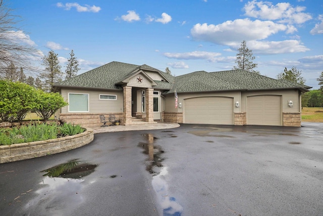6919 E Spangle-Waverly Rd, Spangle, WA 99031 - view of front of property with driveway, a garage, roof with shingles, and stone siding