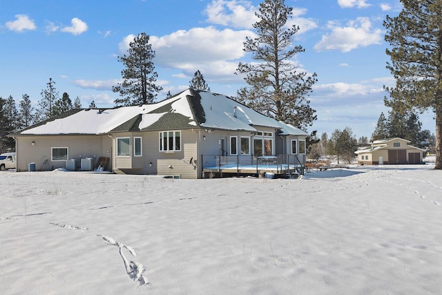 snow covered property featuring a wooden deck