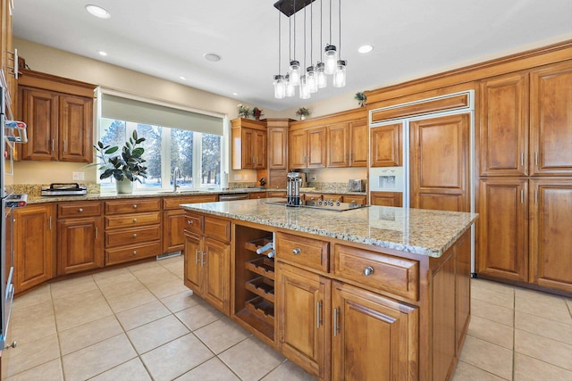 kitchen featuring pendant lighting, light tile patterned floors, black electric stovetop, light stone countertops, and a kitchen island