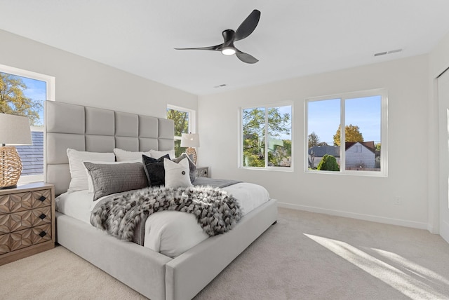 bedroom with ceiling fan and light carpet