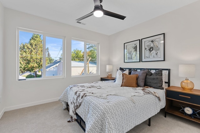 bedroom with light colored carpet and ceiling fan