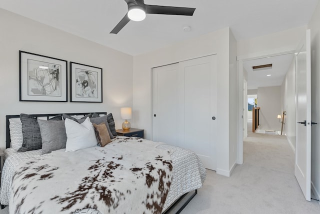 carpeted bedroom featuring a closet and ceiling fan