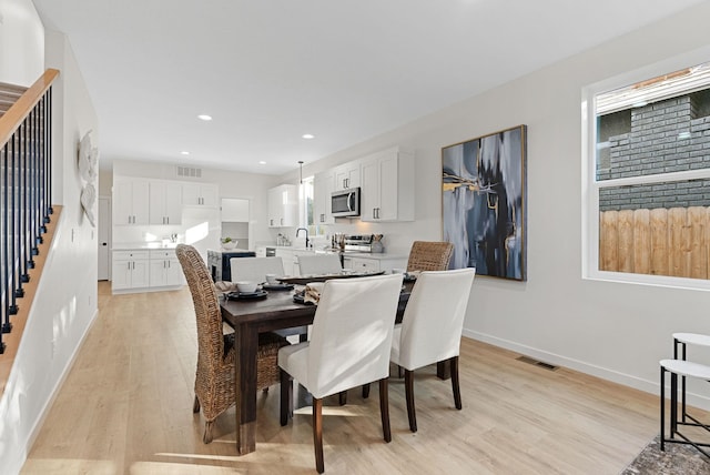 dining space featuring light wood-type flooring