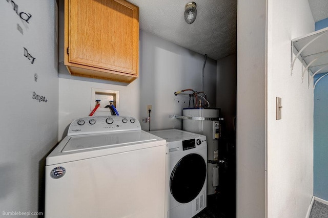 laundry room featuring washer and dryer, strapped water heater, cabinets, and a textured ceiling