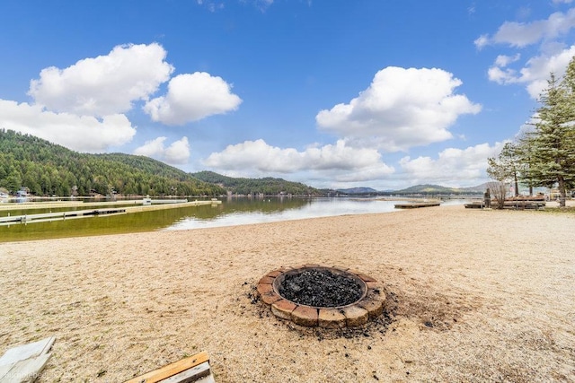 water view featuring a mountain view and a fire pit