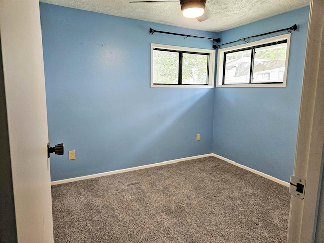 empty room featuring ceiling fan, carpet flooring, and a textured ceiling