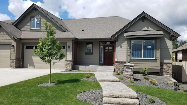 craftsman-style home featuring a garage and a front lawn