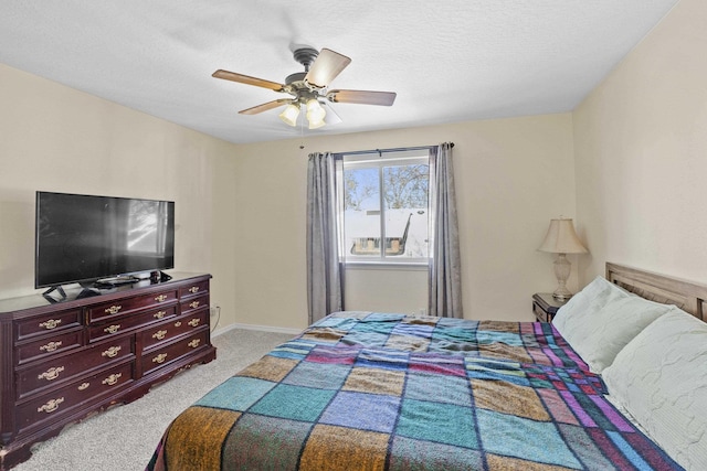 carpeted bedroom with ceiling fan and a textured ceiling