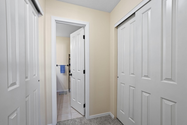 hallway with light colored carpet