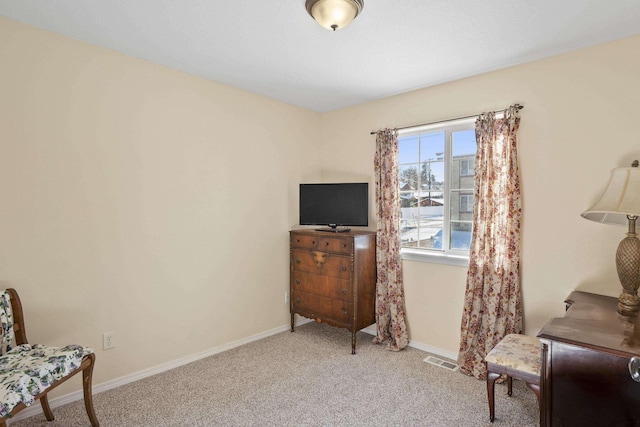 sitting room featuring light colored carpet