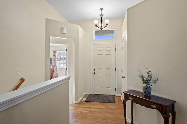 entrance foyer featuring a notable chandelier and light hardwood / wood-style floors