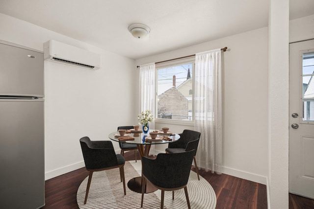 dining space featuring dark wood-type flooring and an AC wall unit