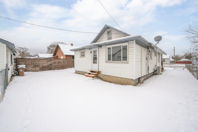 view of snow covered back of property