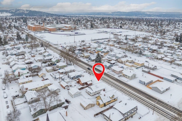 snowy aerial view featuring a mountain view