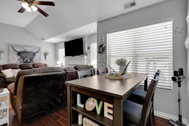 dining space with dark wood-type flooring, ceiling fan, and lofted ceiling