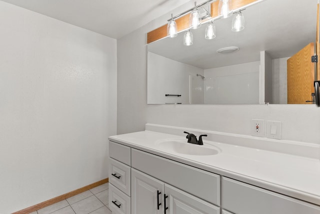 bathroom featuring vanity, tile patterned floors, and a shower