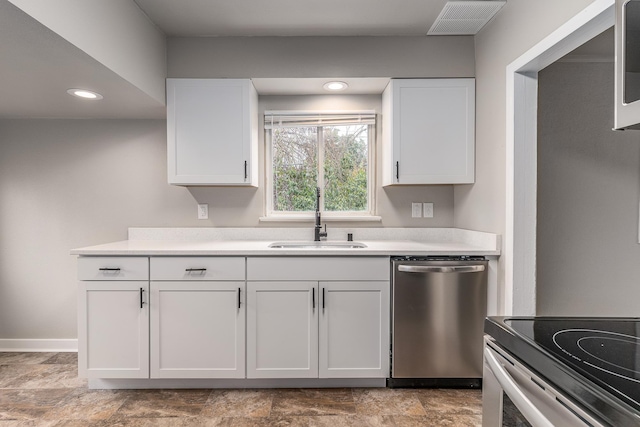 kitchen with dishwasher, sink, and white cabinets