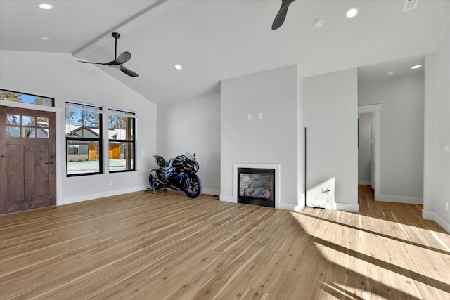 unfurnished living room featuring ceiling fan, beam ceiling, high vaulted ceiling, and light wood-type flooring