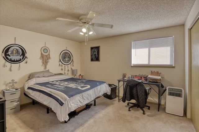 carpeted bedroom with ceiling fan, a textured ceiling, and a closet