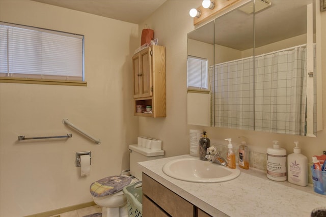 bathroom with vanity, curtained shower, and toilet