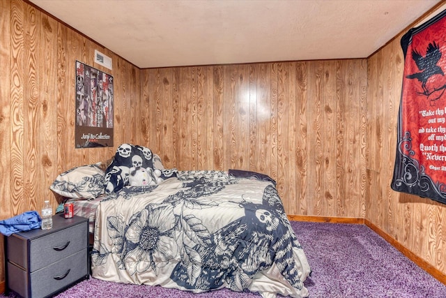 bedroom with carpet floors and wood walls