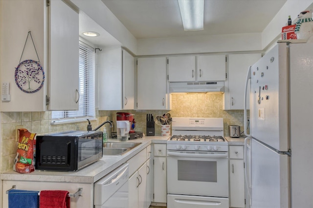 kitchen with white appliances, sink, decorative backsplash, and white cabinets