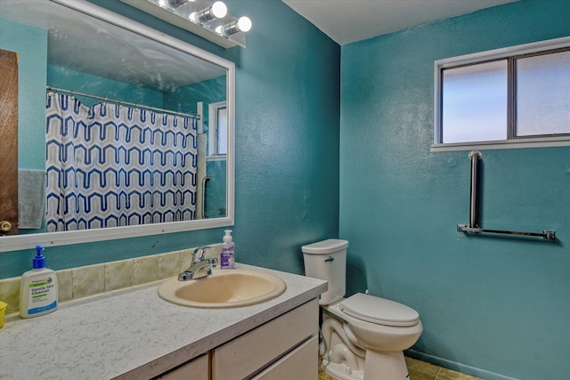 bathroom featuring a shower with curtain, vanity, toilet, and tile patterned flooring