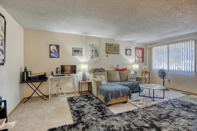 carpeted living room featuring a wall mounted air conditioner and a textured ceiling