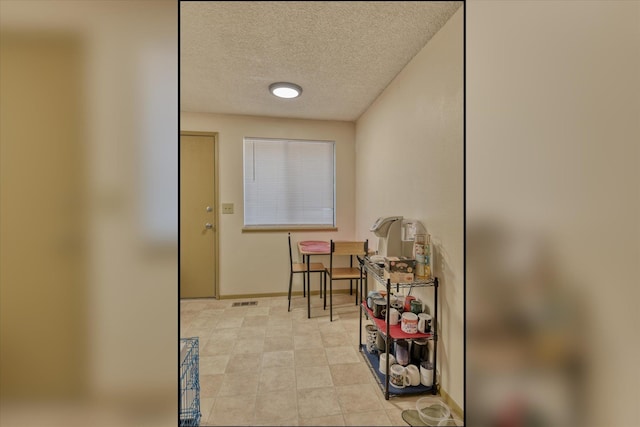 doorway with a textured ceiling