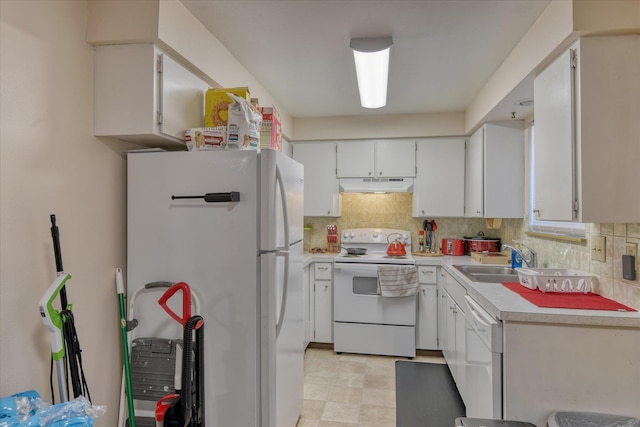 kitchen with backsplash, white appliances, sink, and white cabinets