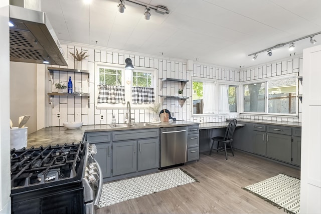 kitchen with open shelves, a sink, stainless steel appliances, gray cabinets, and rail lighting