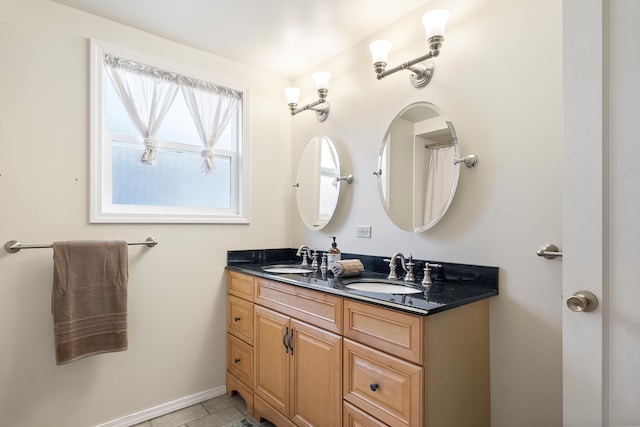 bathroom with tile patterned floors and vanity