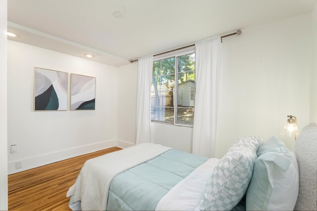 bedroom featuring recessed lighting, baseboards, and wood finished floors